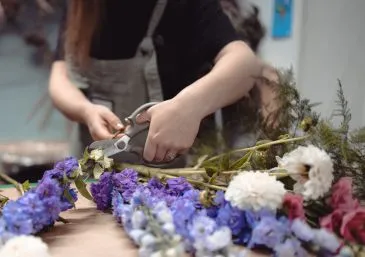 A participant arranging flowers in a structure floristry class at Booker Flowers and Gifts, Liverpool.